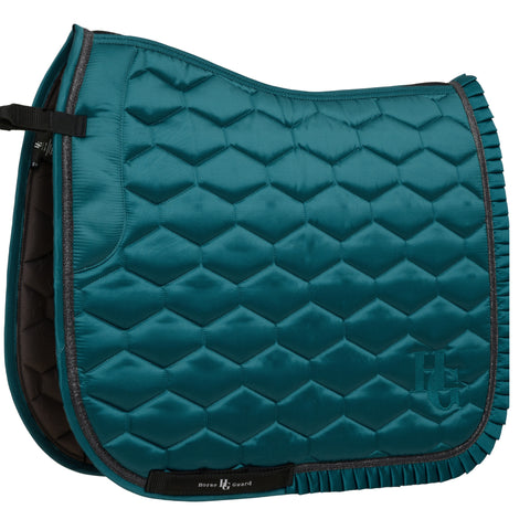 Teal quilted saddle pad with brand logo on a white background